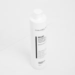White bottle of Colorlab Relief Shampoo on a white background